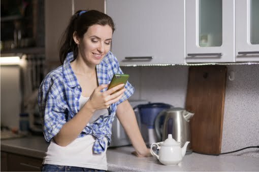woman_using_mobile_in_kitchen Boiler Finance